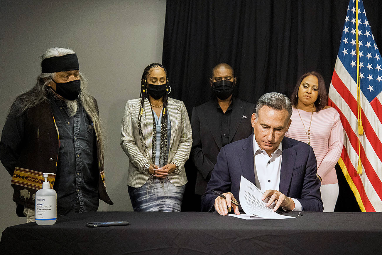 King County Executive Dow Constantine signs an order July 28 to restart inquests into deaths that involved police officers. COURTESY PHOTO, King County
