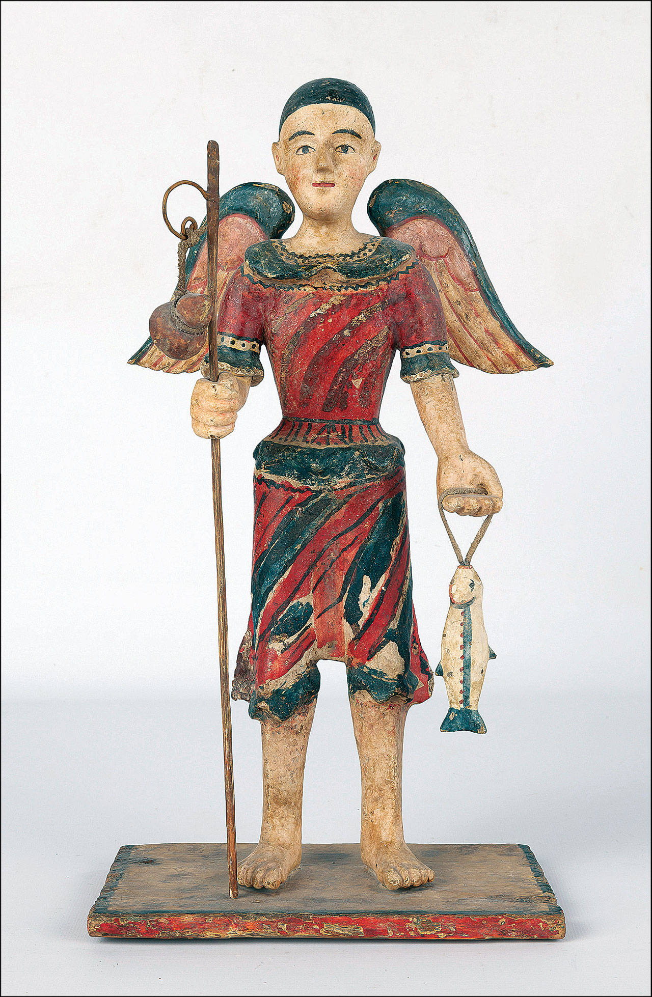 The 13-inch-high antique wooden San Rafael figure with wings and holding a staff and a fish sold at a Cottone auction for $9,600. (Cowles Syndicate Inc.)