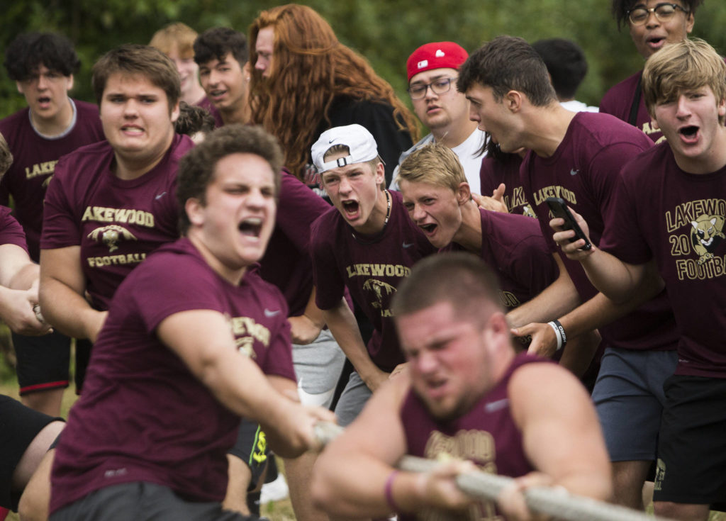 Lakewood High School football players cheer on their lineman during the Cougars Championship Lineman Challenge at Lakewood High School on July 31 in Arlington. (Olivia Vanni / The Herald)