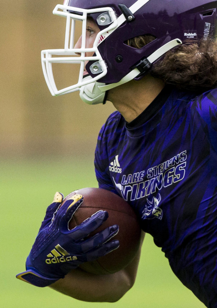 Lake Stevens’ Drew Carter runs the football during the Cougars Championship Passing Tournament at Lakewood High School on July 31 in Arlington. (Olivia Vanni / The Herald)