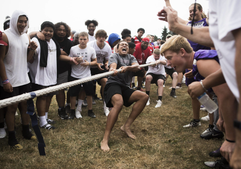 Mercer islands’ Cole Drayton yells as his team wins the tug-o-war event during the Cougars Championship Lineman Challenge at Lakewood High School on July 31 in Arlington. (Olivia Vanni / The Herald)