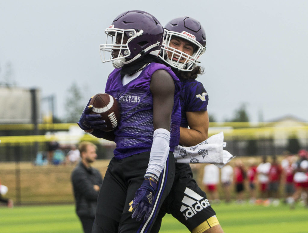 Lake Stevens’ Isaac Redford (left) and Drew Carter (right) celebrate a touchdown during the Cougars Championship Passing Tournament at Lakewood High School on July 31 in Arlington. (Olivia Vanni / The Herald)
