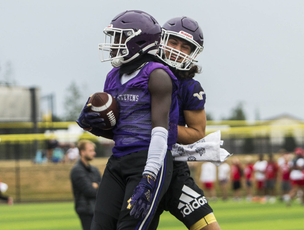 Lake Stevens’ Isaac Redford (left) and Drew Carter (right) celebrate a touchdown during the Cougars Championship Passing Tournament at Lakewood High School on July 31 in Arlington. (Olivia Vanni / The Herald)