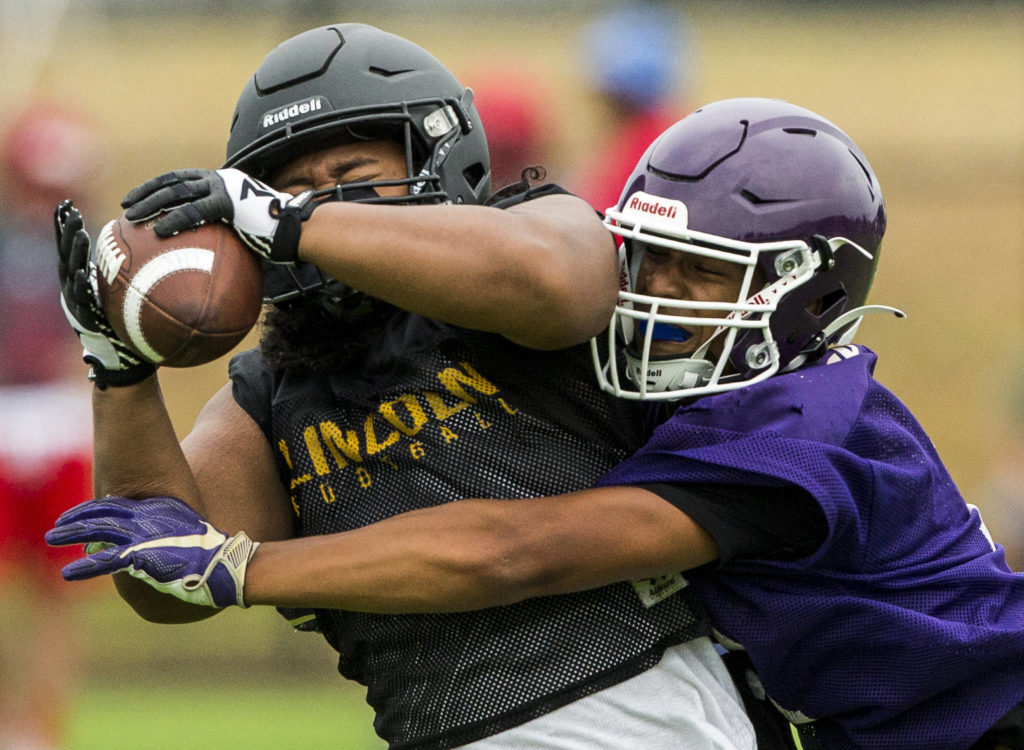 Lake Stevens’ Joey Dosen tries to block a pass during the Cougars Championship Passing Tournament at Lakewood High School on July 31 in Arlington. (Olivia Vanni / The Herald)
