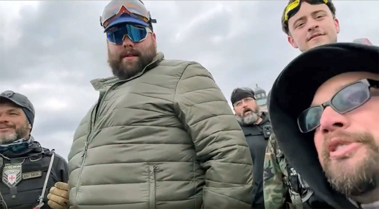 Daniel Scott (in green jacket) and Eddie Block (bottom right) are shown in a video before the Proud Boys and other rioters stormed the U.S. Capitol building on Jan. 6 in Washington, D.C. (YouTube)