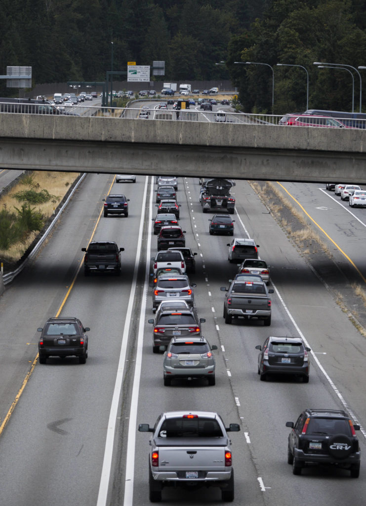 General purpose lane traffic on I-405 north stops underneath the overpass of Highway 527 while express toll lane traffic on the left moves Friday in Bothell. The state plans to build a second toll lane between Highways 522 and 527. (Olivia Vanni / The Herald)
