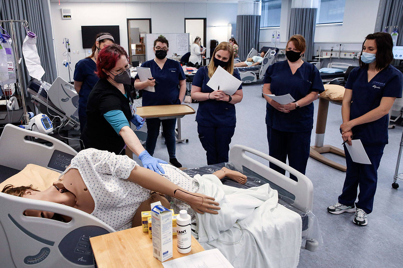 Catherine Robinweiler leads the class during a lab session at Edmonds College on April 29. (Kevin Clark / Herald file)