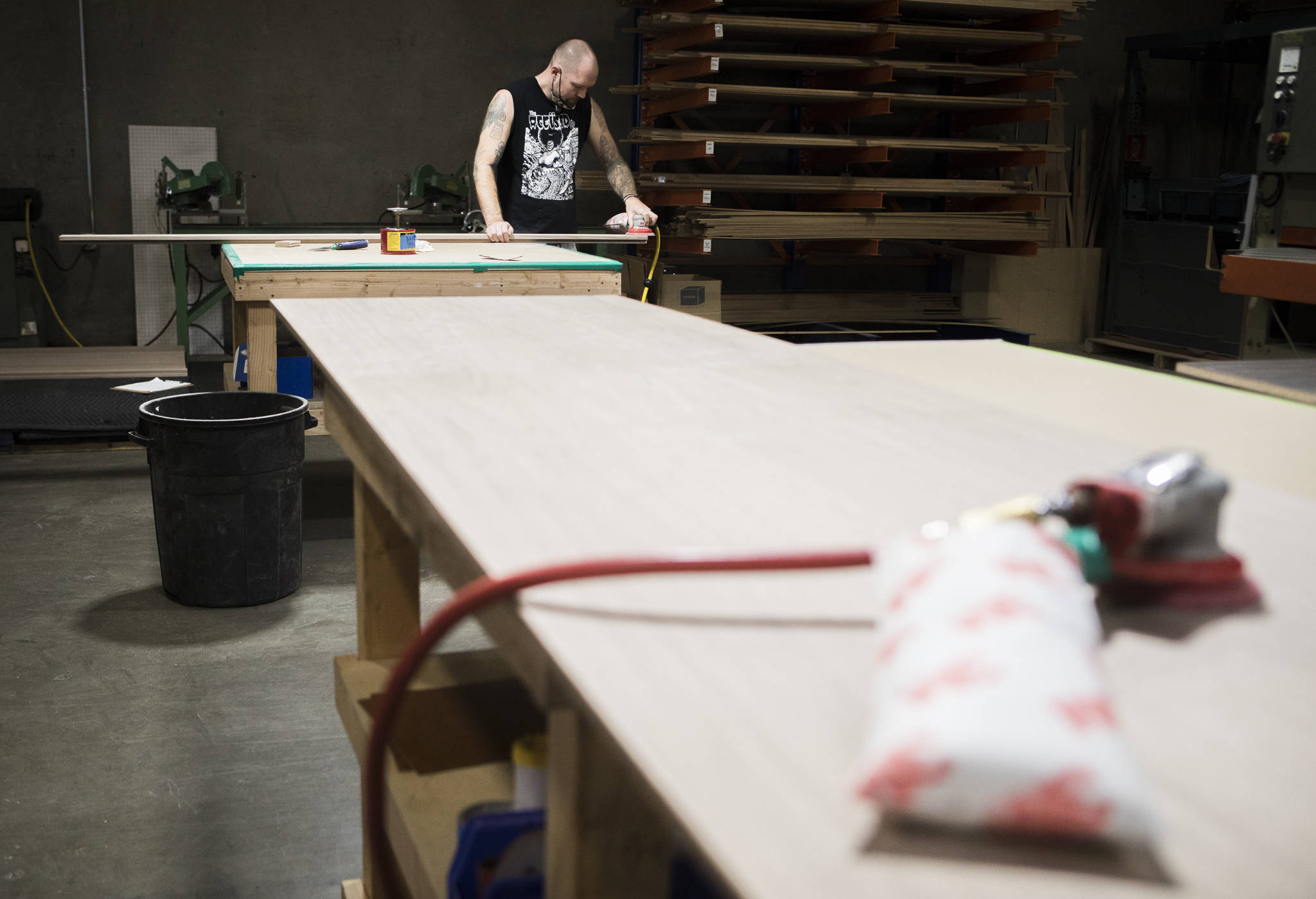 An employee sands a board at Ironwood Manufacturing’s new Arlington factory. (Olivia Vanni / The Herald)