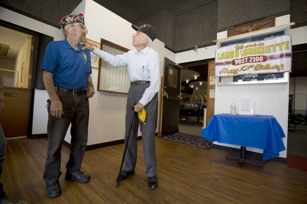 After showing off a few tap-dancing moves, Donald Wischmann (left) gets a little teasing from World War II veteran Larry Negrette, who was celebrating his 101st birthday at the Everett VFW Post on Tuesday. (Andy Bronson / The Herald)
