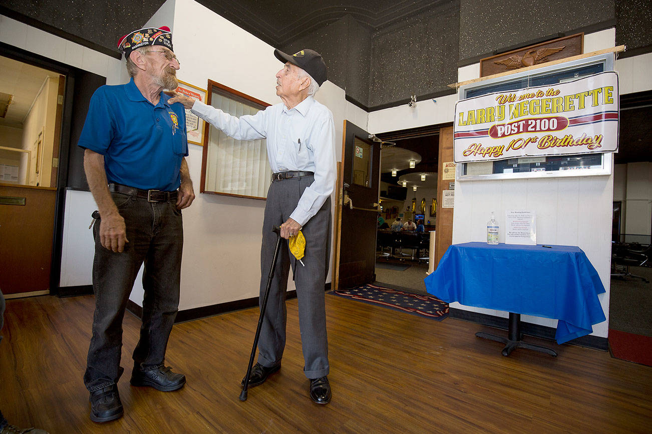 After showing off a few tap-dancing moves, Donald Wischmann, left, gets a little teasing from World War II veteran Larry Negrette, who was celebrating his 101st birthday at the Everett VFW Post 2100 on Tuesday, Aug. 10, 2021 in Everett, Washington. Negrette served as a gunner on B-17 bombers during the war.  (Andy Bronson / The Herald)
