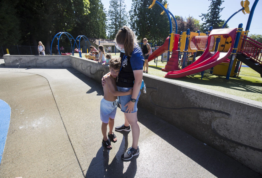 A moment of frustration finds Haaken Williams holding onto Camp Prov unit leader Sarah Walters at Forest Park in Everett on Wednesday. (Andy Bronson / The Herald) 
