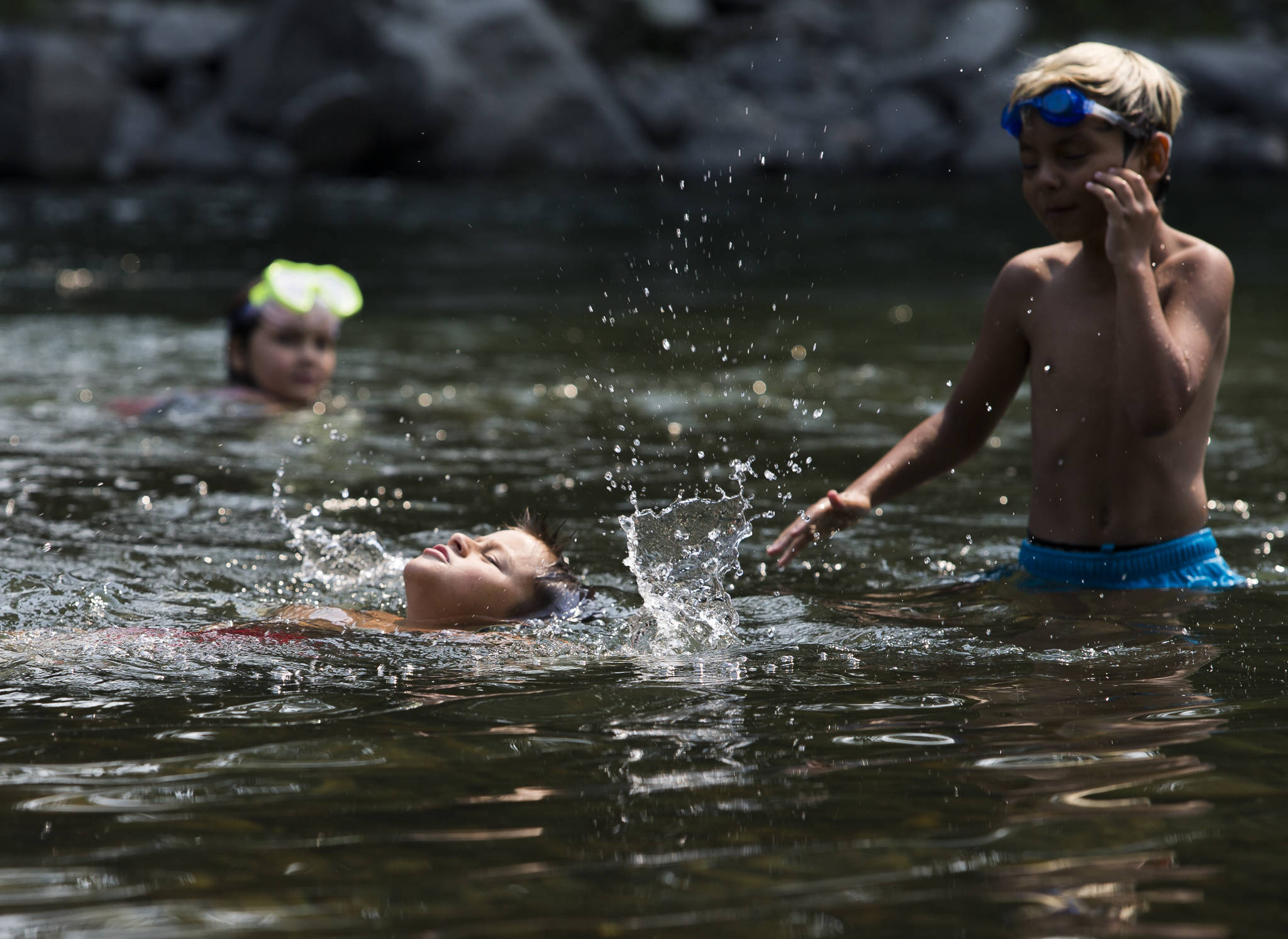 Lightning Powers, 8, comes up for air while swimming in the South Fork Stillaguamish River on Friday in Arlington. (Olivia Vanni / The Herald)