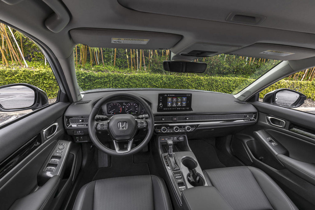 A honeycomb-patterned mesh panel concealing the air vents is an attractive design feature of the 2022 Honda Civic Sedan. The Touring interior is shown here. (Honda) 
