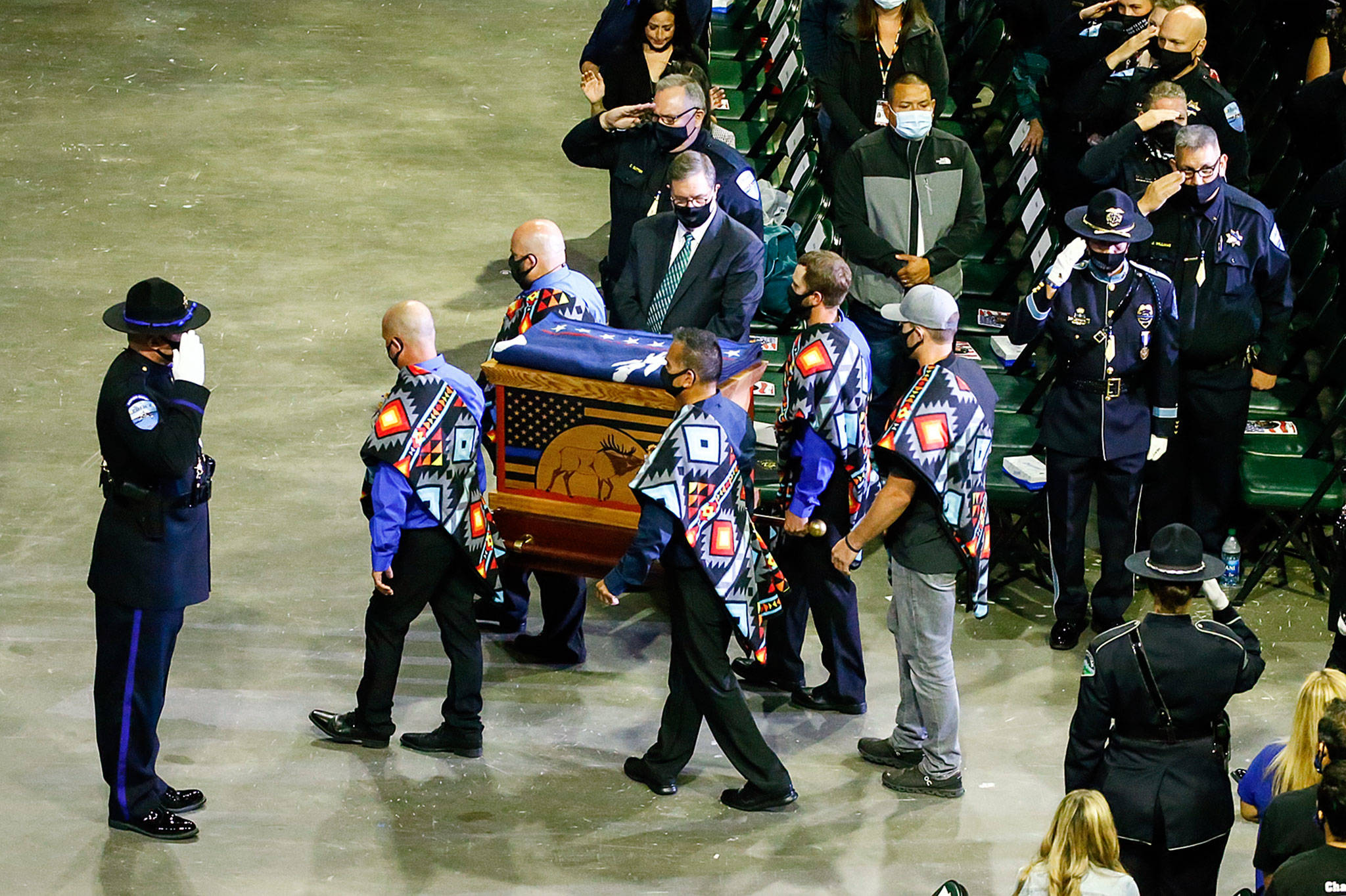 The symbolic remains of Officer Charlie Joe Cortez are carried at a memorial service for him Tuesday at Angel of the Winds Arena in Everett. (Kevin Clark / The Herald)