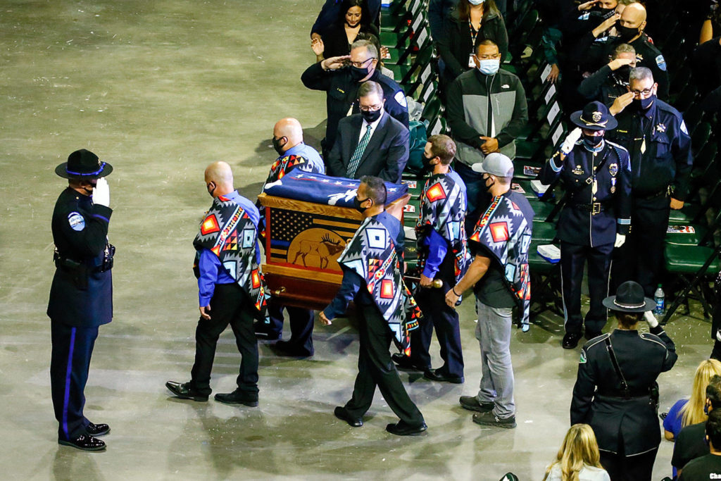 The symbolic remains of Officer Charlie Joe Cortez are carried at a memorial service for him Tuesday at Angel of the Winds Arena in Everett. (Kevin Clark / The Herald)
