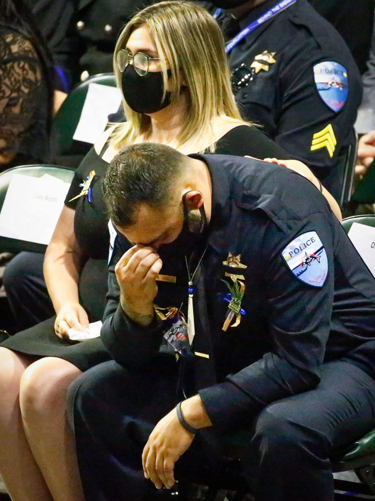 Tulalip Fish & Wildlife Officer Beau Jess mourns his lifelong friend and fellow officer, Charlie Joe Cortez, on Tuesday at Angel of the Winds Arena in Everett. (Kevin Clark / The Herald)
