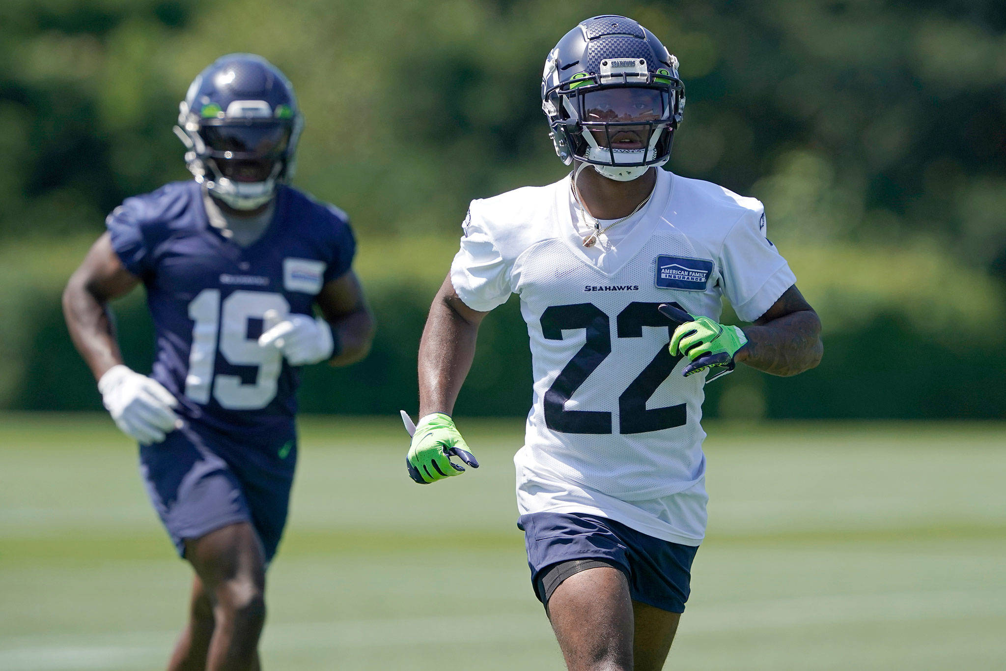 Seahawks rookie cornerback Tre Brown (22) runs with wide receiver Penny Hart during a practice on July 29, 2021, in Renton. (AP Photo/Ted S. Warren)
