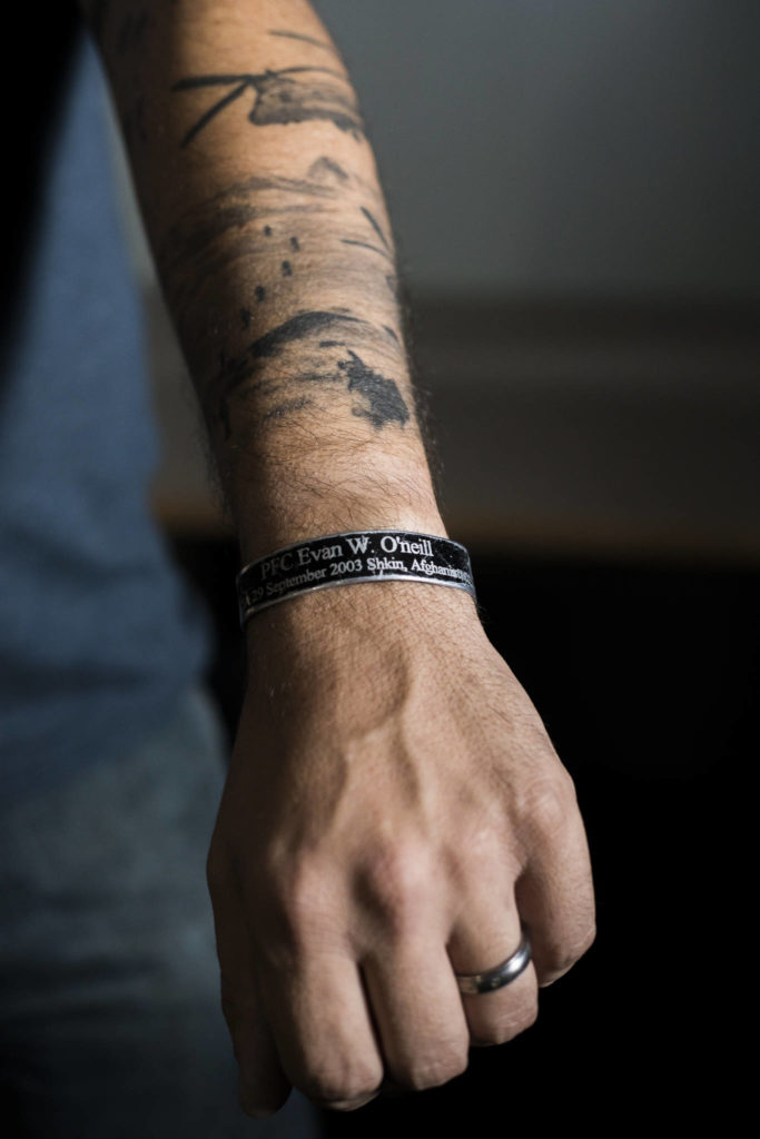 Drew James wears a band on his arm with the name of fellow veteran and friend Evan W. O’neil, who died in Afghanistan. (Olivia Vanni / The Herald)
