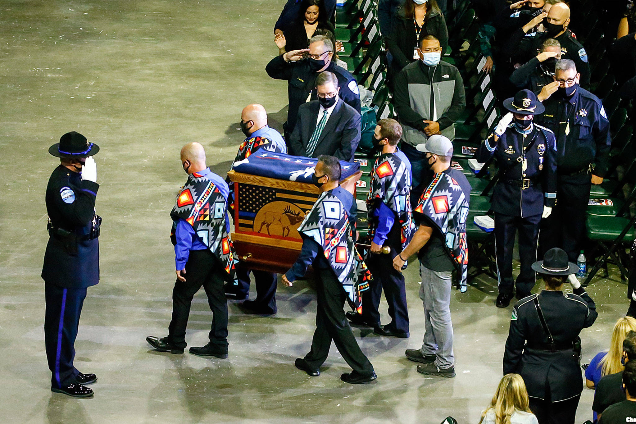 The symbolic remains of Officer Charlie Joe Cortez is carried in to start the memorial service for Officer Cortez Tuesday afternoon at the Angel of the Winds Arena in Everett on August 17, 2021.  (Kevin Clark / The Herald)