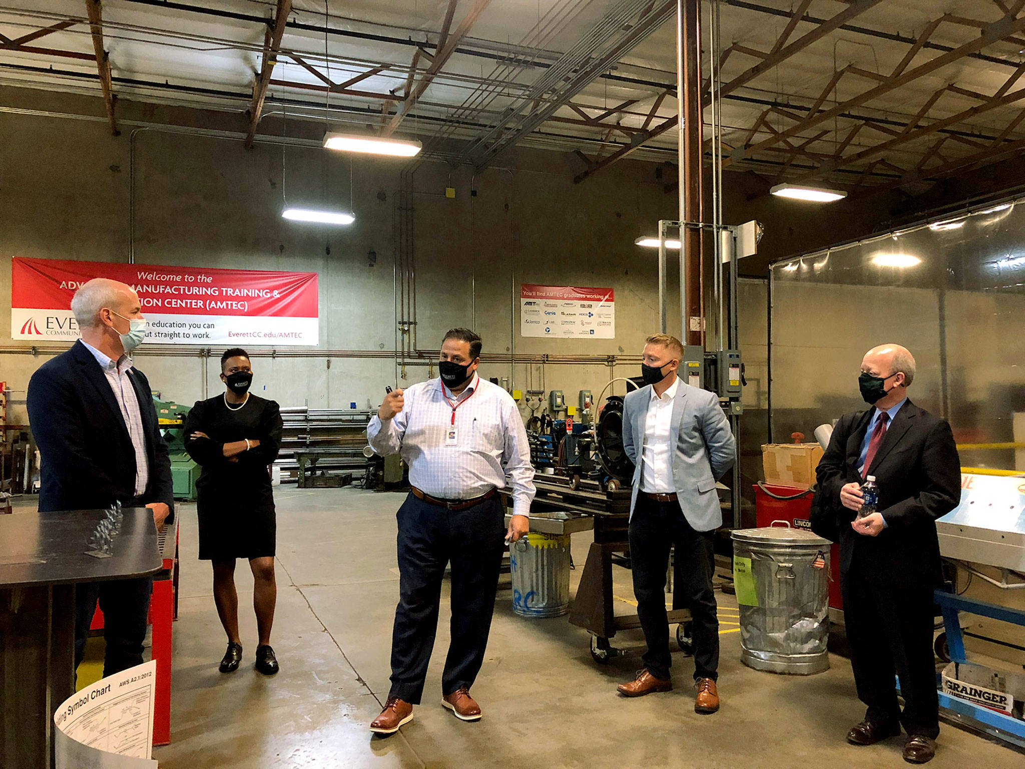 From left, U.S. Rep. Rick Larsen, D-Everett; Everett Community College President Daria Willis; Herman Calzadillas, dean of the college’s Advanced Manufacturing Training and Education Center; Brandon Anderson, legislative director for the Society of Professional Engineering Employees in Aerospace; and Elliott Black, director of U.S. Department of Transportation’s Aviation Manufacturing Jobs Protection Program. They were touring the Advanced Manufacturing Center at EvCC on Friday. (Janice Podsada / The Herald)