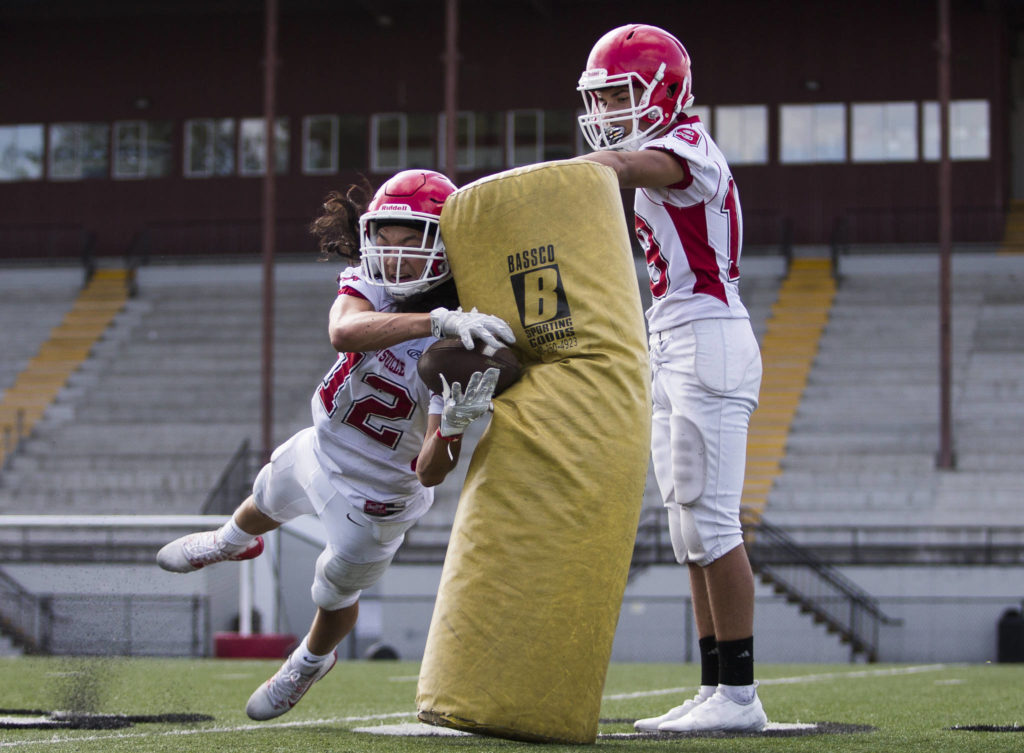Marysville Pilchuck’s Carson Asper dives to make a catch during a drill at football practice on Thursday in Marysville. (Olivia Vanni / The Herald)
