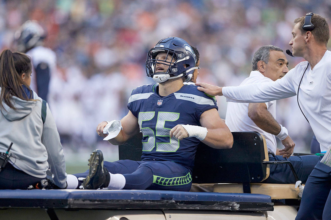 Seattle Seahawks’ Ben Burr-Kirven is driven off the field on a cart after an injury during the first half of a preseason game against the Denver Broncos on Saturday in Seattle. (AP Photo/John Froschauer)