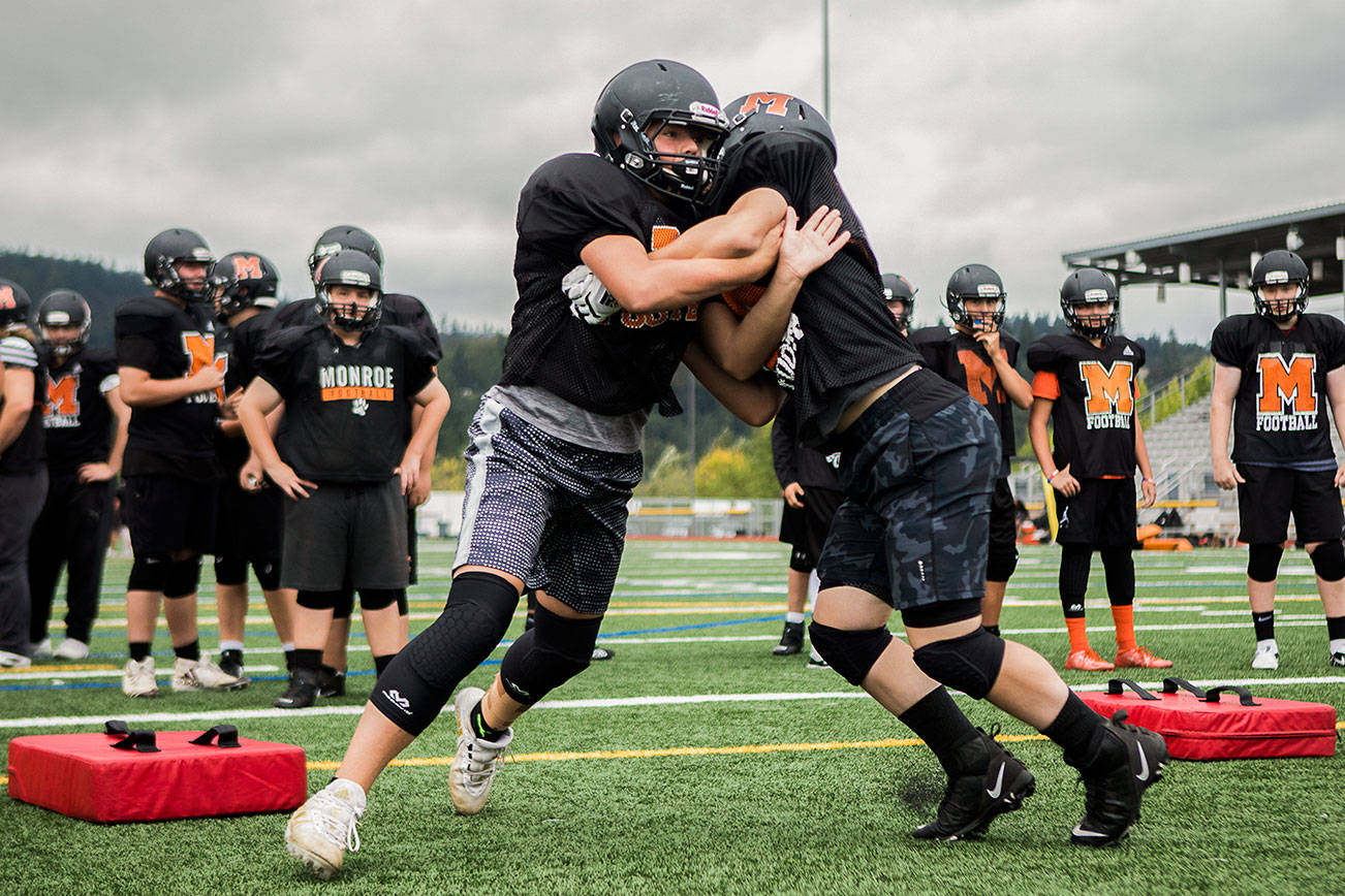 The Monroe football team defense runs through drills during football practice on Thursday, Aug. 26, 2021 in Monroe, Wash. (Olivia Vanni / The Herald)