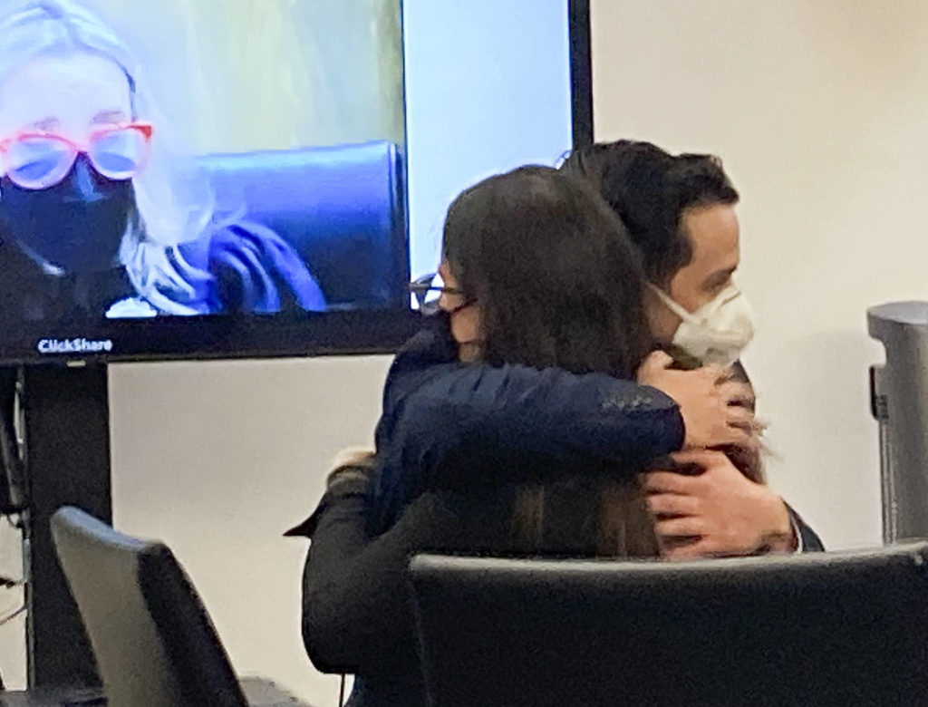 Anthony Zayas hugs defense attorney Samantha Sommerman after a jury acquitted the former sheriff’s deputy of third-degree child rape on Monday in Everett. (Herald staff) 
