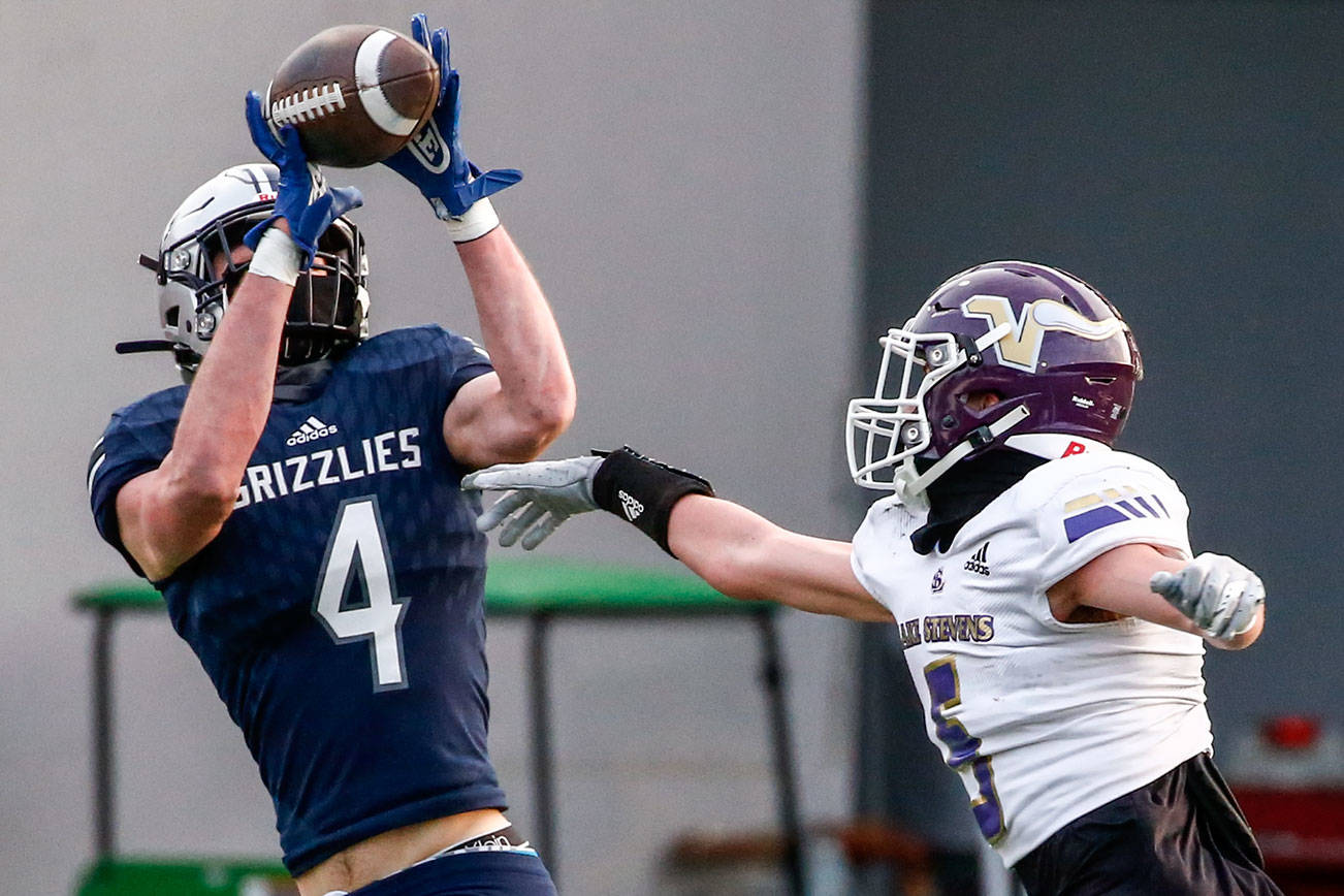 Glacier Peak’s Cooper Jensen makes a touchdown reception against Lake Stevens’ Alexander Davis Thursday night at Veterans Memorial Stadium in Snohomish on April 1, 2021. (Kevin Clark / The Herald)