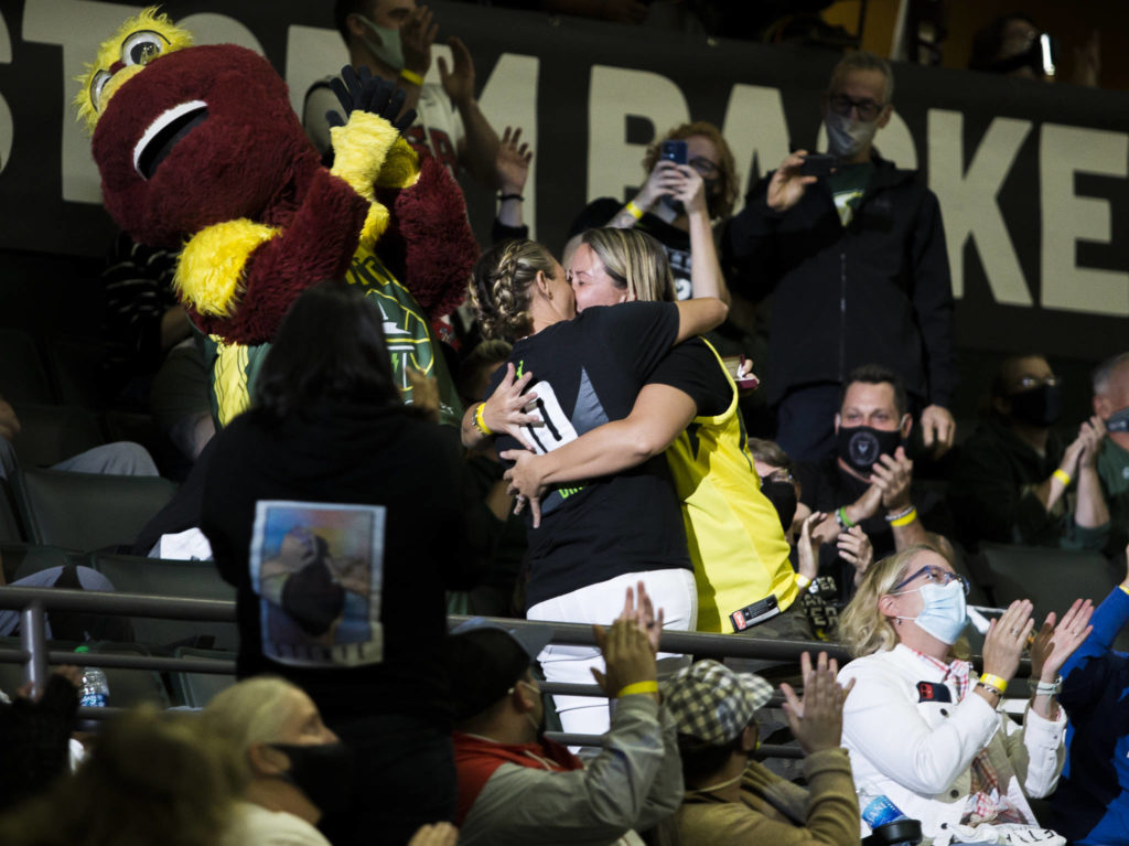 A couple kisses after an engagement during the game against the Chicago Sky at Angel of the Winds Arena on Friday, Aug. 27, 2021 in Everett, Wash. (Olivia Vanni / The Herald)
