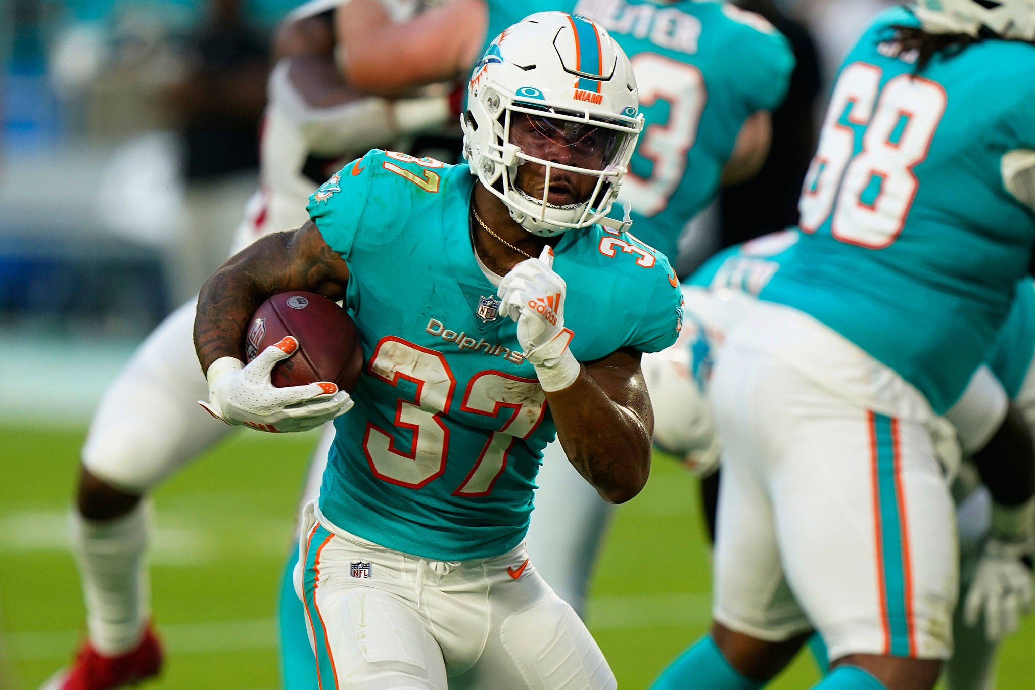 Dolphins running back Myles Gaskin, a Lynnwood native, carries the ball during the first half of a preseason game against the Falcons on Aug. 21, 2021, in Miami Gardens, Fla. (AP Photo/Wilfredo Lee)