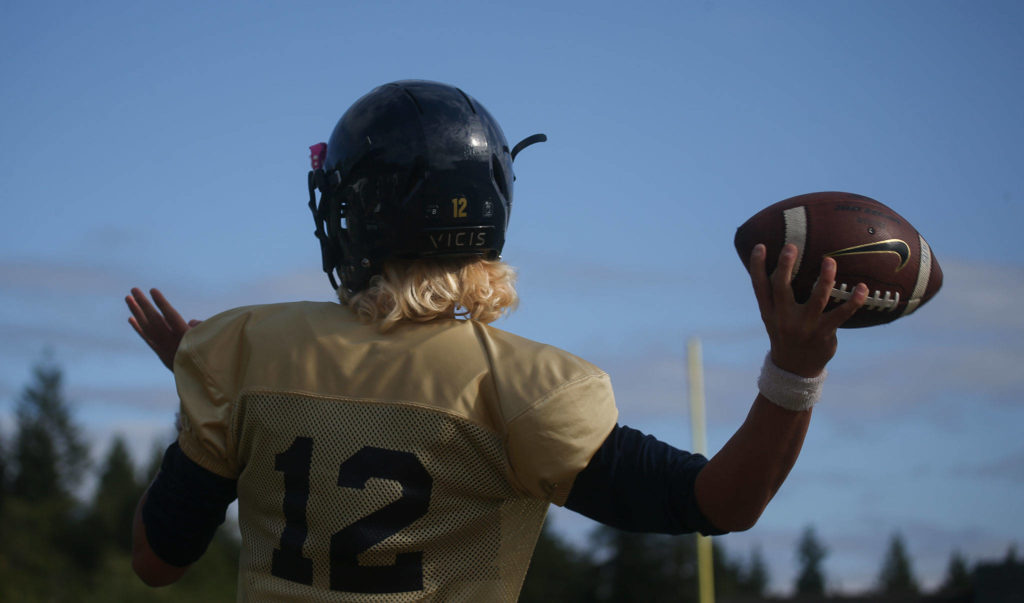 Trent Nobach throws a pass during practice Tuesday in Arlington. (Andy Bronson / The Herald)
