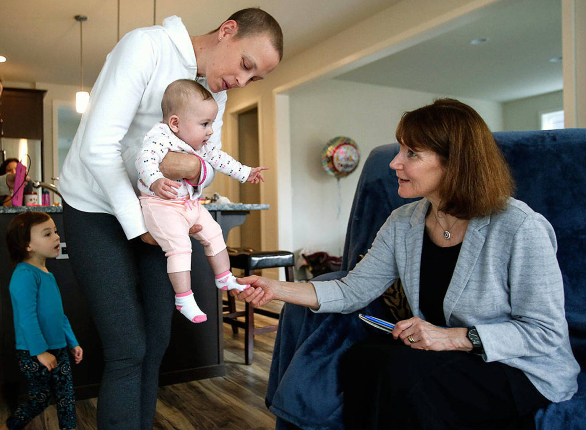 In June of 2016, Apryl DeBroeck Roberts, followed by her 2-year-old daughter Charlee, brings baby Haven to meet Julie Muhlstein. (Dan Bates / Herald file)