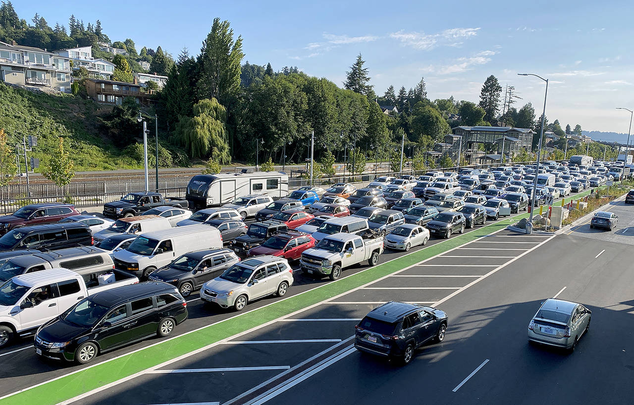 Ferry terminals are expected to see peak travel westbound Thursday to Saturday. Here, cars line up waiting to board the ferry from Mukilteo to Clinton on July 28. (Sue Misao / Herald file)