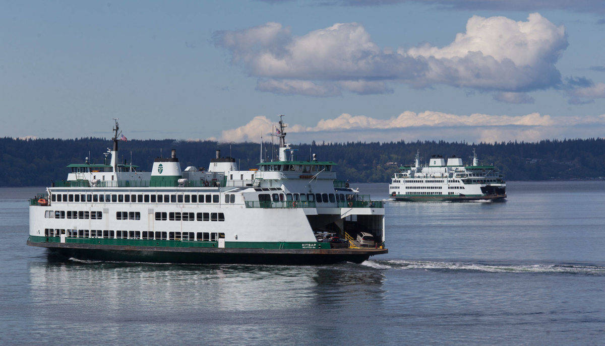 Ferries pass on a crossing between Mukilteo and Whidbey Island. (Andy Bronson / The Herald)