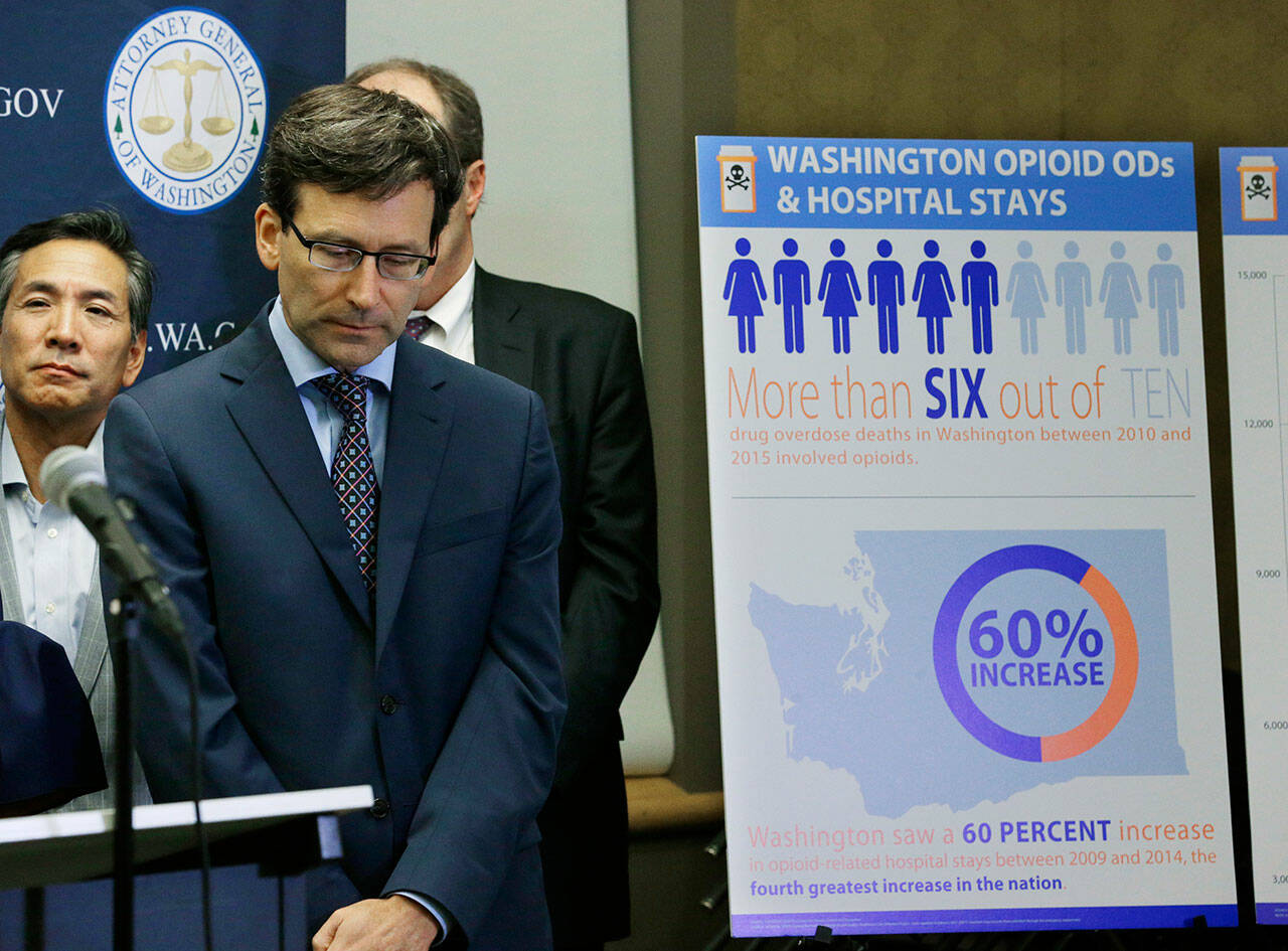 Washington Attorney General Bob Ferguson listens to a question, Sept. 28, 2017, in Seattle, as he stands near a chart detailing increases in overdoses and hospital stays relating to opioid use in Washington state. Ferguson announced Wednesday his plans to appeal a bankruptcy settlement in federal court that would require the Sackler family, former owners of Purdue Pharma, to pay $4.3 billion. (Ted S. Warren / Associated Press file photo)