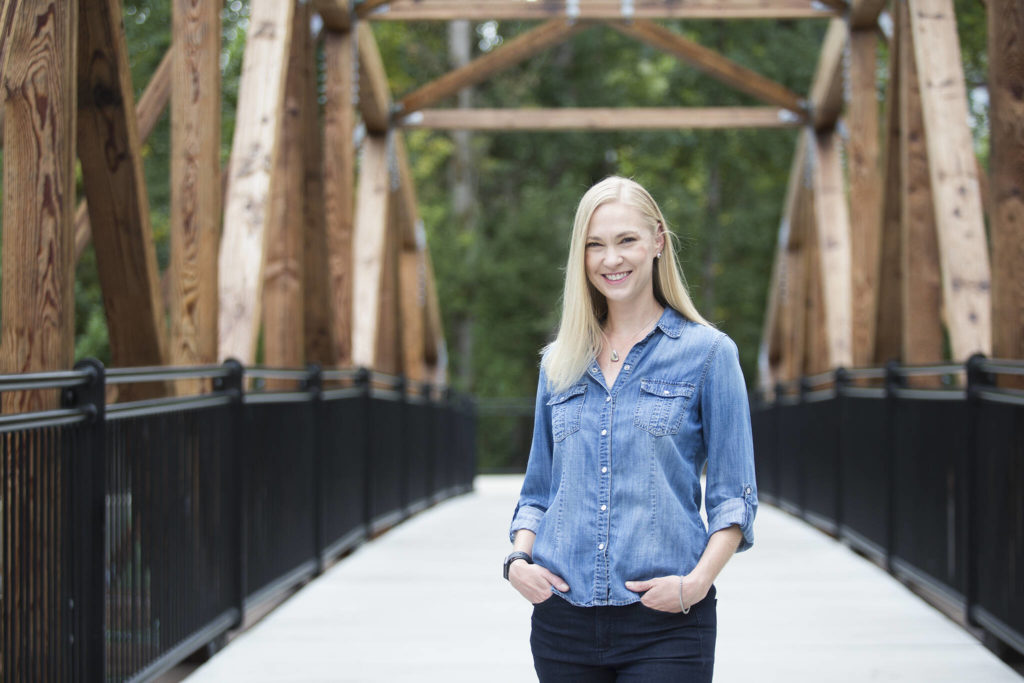 Writer Amanda Johnson, seen here Monday at the The Park at Bothell Landing, has just published her first book, “East of Manhattan.” (Andy Bronson / The Herald)
