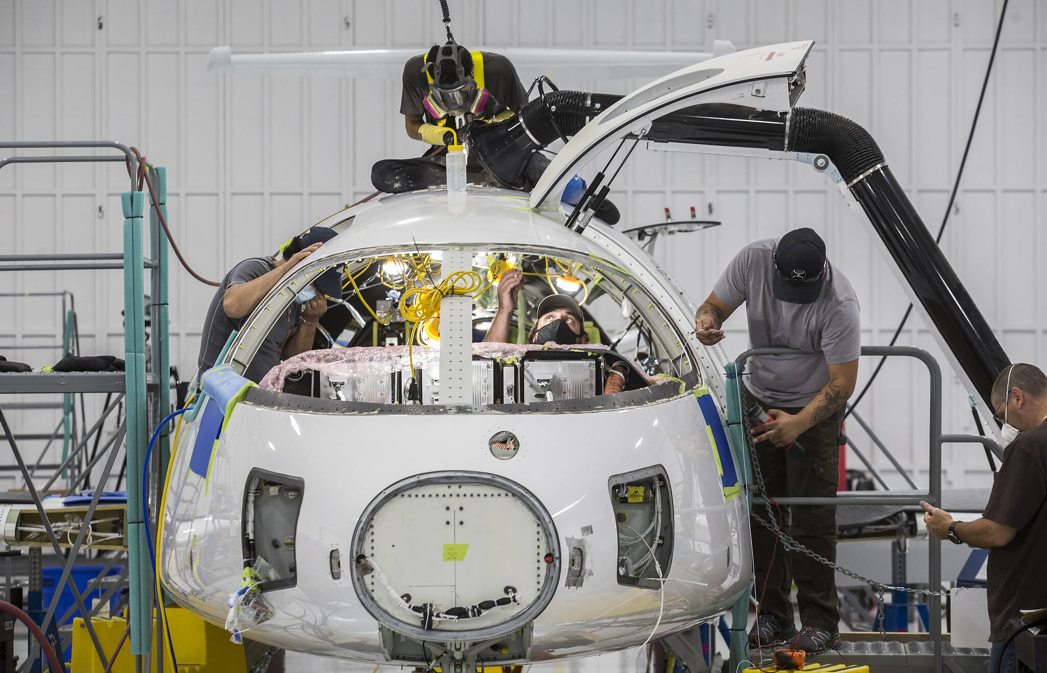 Workers build the first all-electric commuter plane, the Eviation Alice, at Eviation’s plant on Sept. 8 in Arlington. (Andy Bronson / The Herald)
