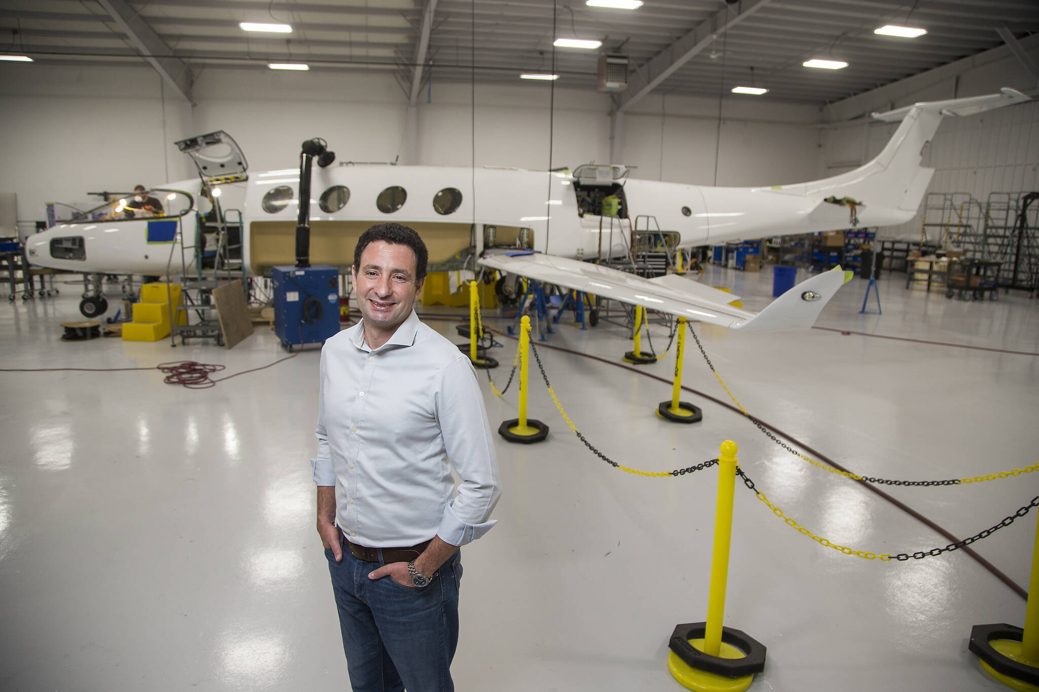 Eviation co-founder and CEO Omer Bar-Yohay stands by the company’s all-electric plane, the Alice, at Eviation’s plant Sept. 8 in Arlington. (Andy Bronson / The Herald)