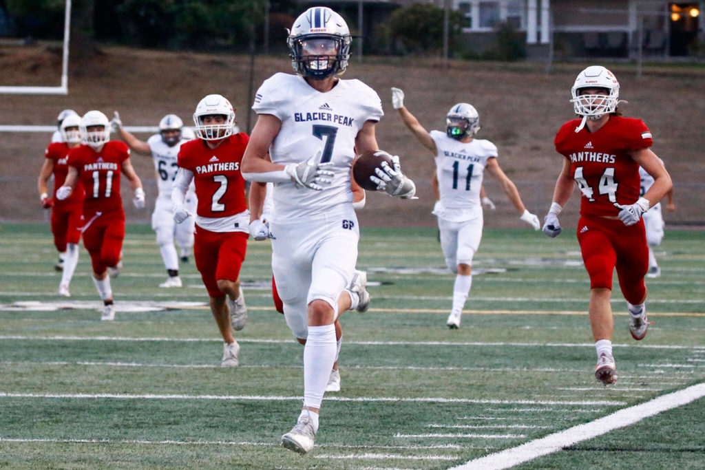 Glacier Peak’s Logan Szarzec outruns the Snohomish defense for a touchdown during the second quarter Friday night at Veteran’s Memorial Stadium in Snohomish. (Kevin Clark / The Herald)
