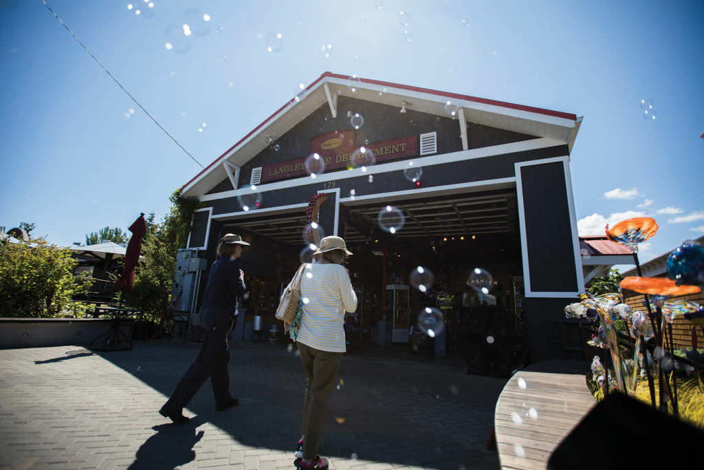 As a bubble machine does its thing, customers walk into Callahan’s Firehouse, a glass-blowing studio, in Langley. (Olivia Vanni / The Herald)
