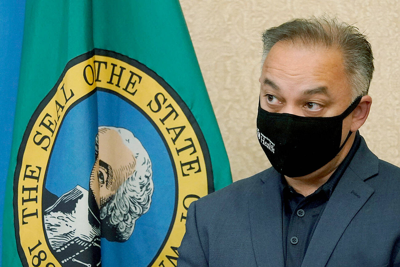 Washington Secretary of Health Umair A. Shah wears a mask as he listens to questions at a news conference with Washington Gov. Jay Inslee, Wednesday, Aug. 18, 2021, at the Capitol in Olympia, Wash. Inslee announced that Washington state is expanding its vaccine mandate to include all public, charter and private school teachers and staff, as well as those working at the state's colleges and universities. Inslee also expanded the statewide indoor mask mandate in place for non-vaccinated individuals to include those who are vaccinated. (AP Photo/Ted S. Warren)