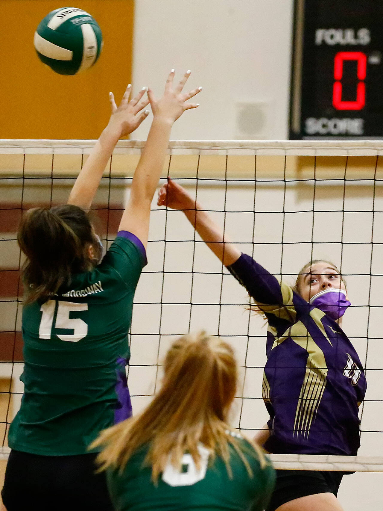 Lake Stevens’ Katelyn Eichert hits over Edmonds-Woodway’s Gretchen Lewis Tuesday night at Edmonds-Woodway High School. The Vikings won in straight sets. (Kevin Clark / The Herald)