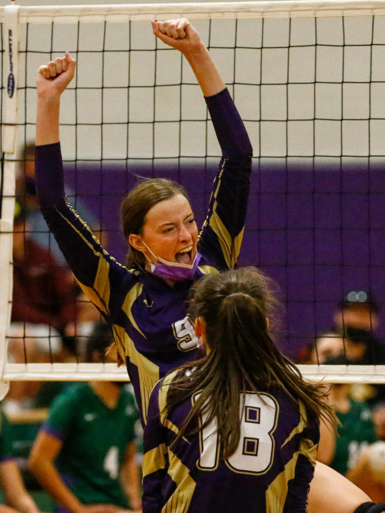 Lake Stevens’ Anna Schroedl (9) celebrates a point with teammates Tuesday night at Edmonds-Woodway High School in Edmonds on September 7, 2021. The Vikings won in straight sets. (Kevin Clark / The Herald)
