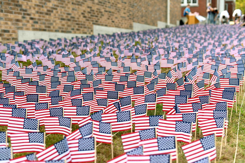 Students, parents and faculty at The Academy of Snohomish marked the 20 years since the terrorist attacks on America by placing 2,977 flags on their campus to pay tribute to each of the lives lost. (Jeri Fodge) 

