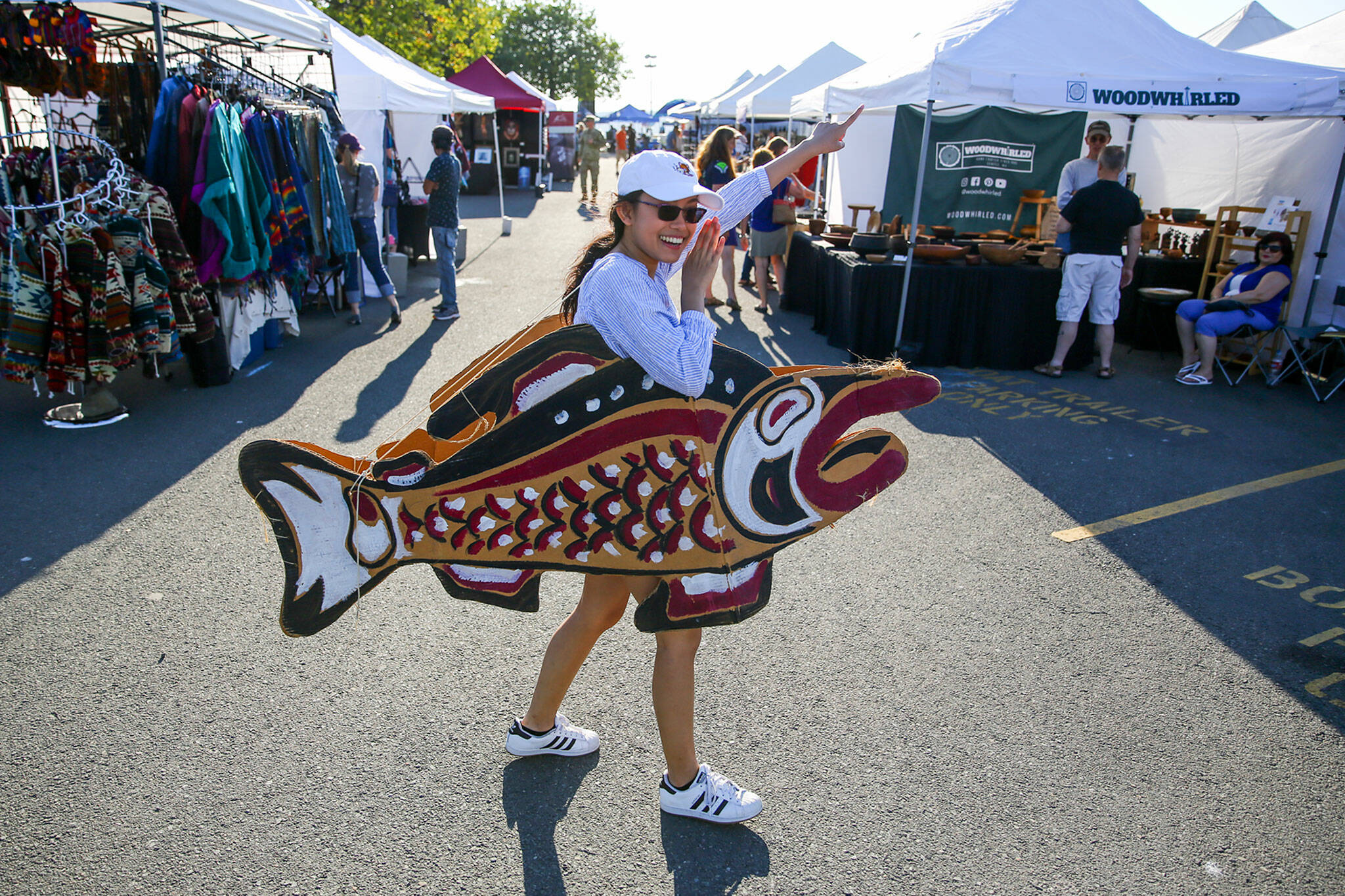 Alina Oeung walks the grounds shouting “free samples” for the Kiwanis Salmon Bake during the Mukilteo Lighthouse Festival in 2019. This year’s festival is Sept. 10-12 at Mukilteo Lighthouse Park. (Kevin Clark / Herald file)