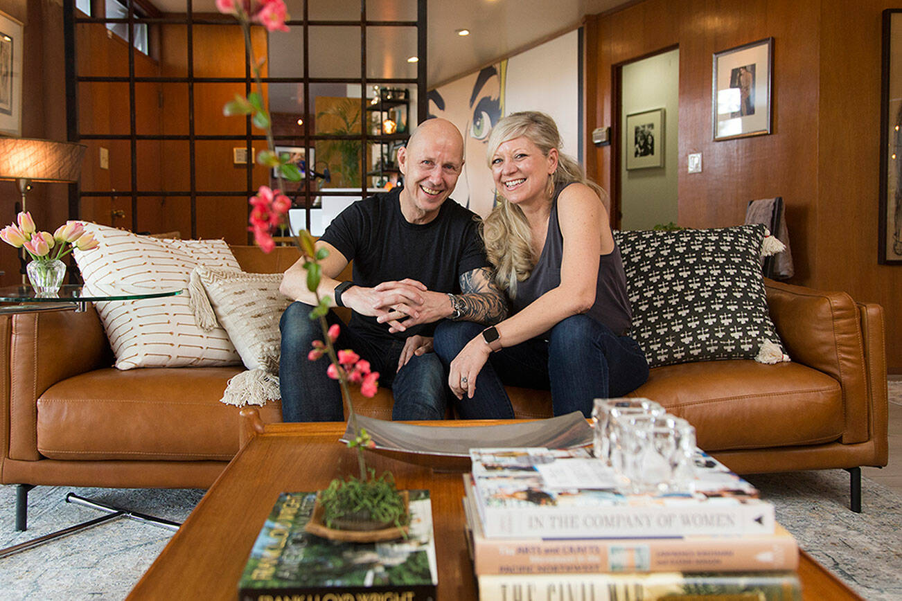 Owners Wendy and Matt Poischbeg sit in the living room of their Mid-Century Modern home, that might have been on the 2020 Historic Everett Home Tour if not for the pandemic, on Monday, April 12, 2021 in Everett, Washington.  (Andy Bronson / The Herald)