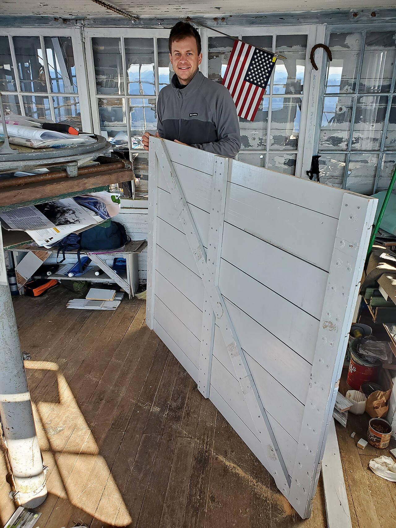 Zach Schrempp readies a new shutter to be installed at Three Fingers Lookout. (Friends of Three Fingers Lookout)