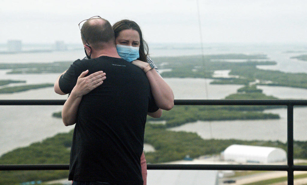 Erin Duncan-Sembroski (right) and her husband, Chris Sembroski, embrace at the top of launch pad 39A at the Kennedy Space Center in Florida in a scene from the Netflix series “Countdown: Inspiration4 Mission to Space.” (Netflix) 
