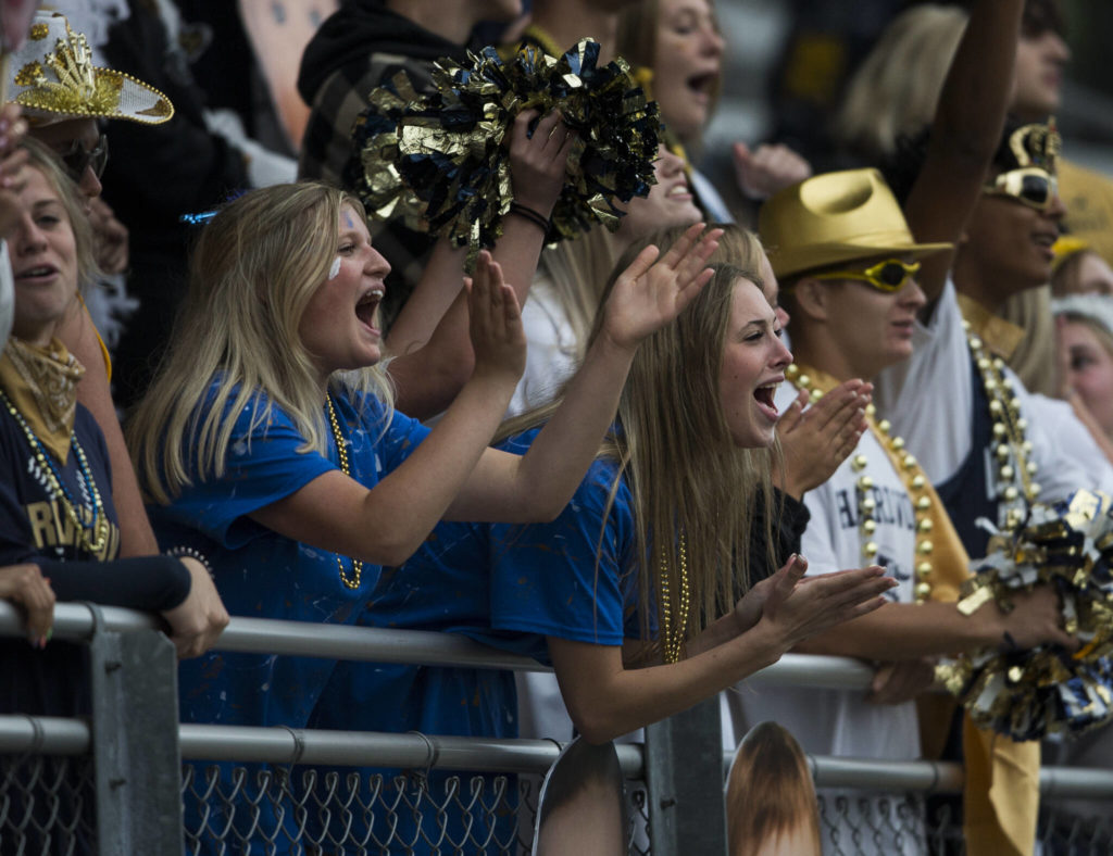 Arlington fans cheer during the game against Oak Harbor on Friday, Sept. 10, 2021 in Arlington, Wa. (Olivia Vanni / The Herald)
